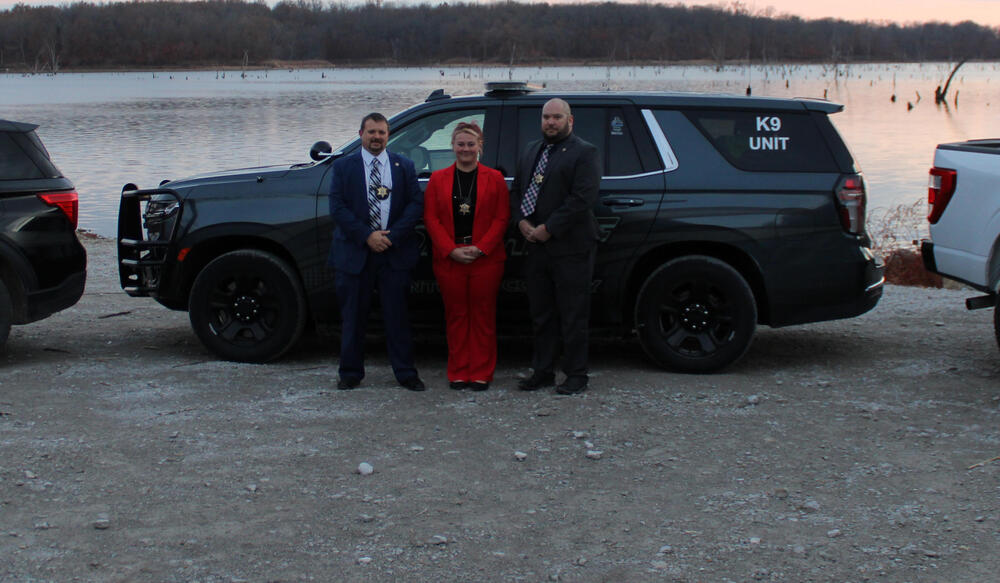 Clinton County Detectives in front of Vehicles